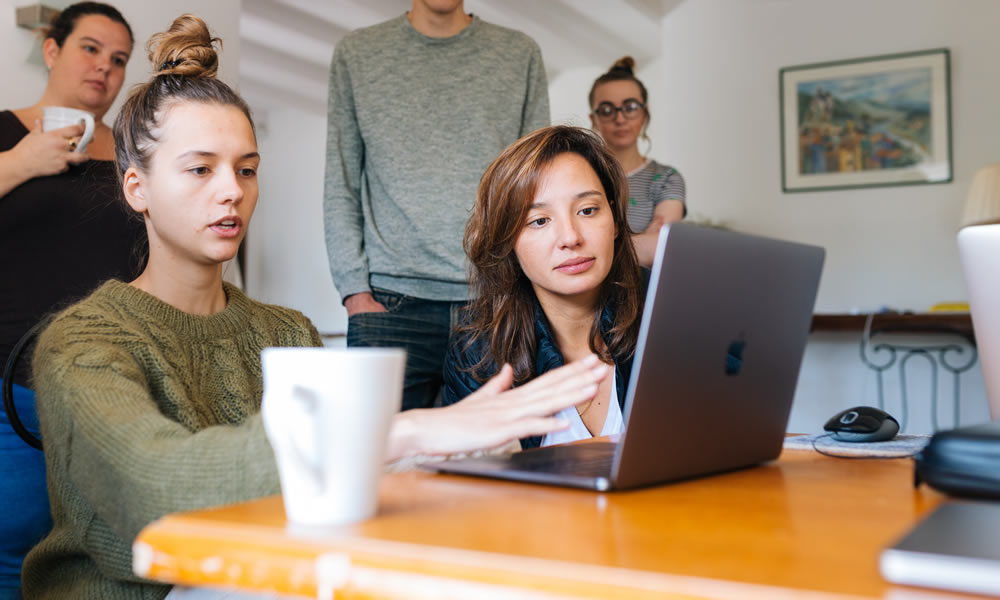 Group gathered around a computer