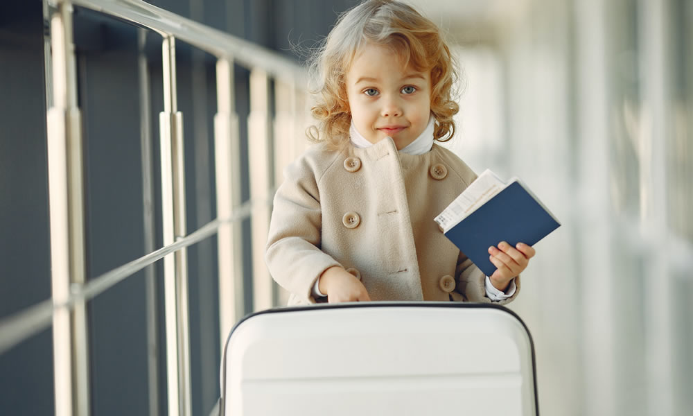 Young girl holding paper identity documents