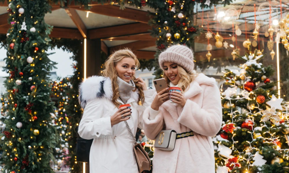 Two blond ladies taking a break at a Christmas market